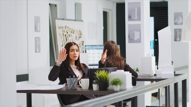Graphic design consultant who uses holographs to shape layouts, real estate agency. Asian designer establishing reconstruction plan using hologram visuals and artificial intelligence. photo