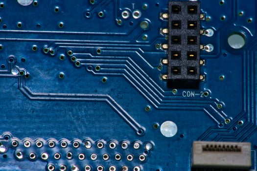 a close up of a circuit board with gold and silver circles photo