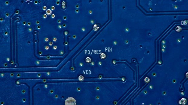 a close up of a circuit board with gold and silver circles photo