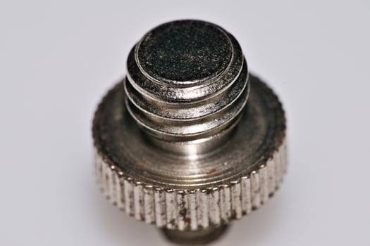 a close up of a metal screw with a small knob photo