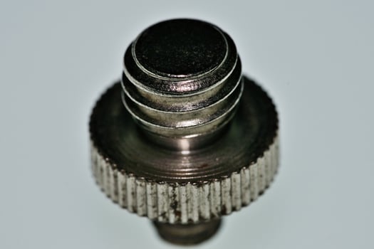 a close up of a metal screw with a small knob photo