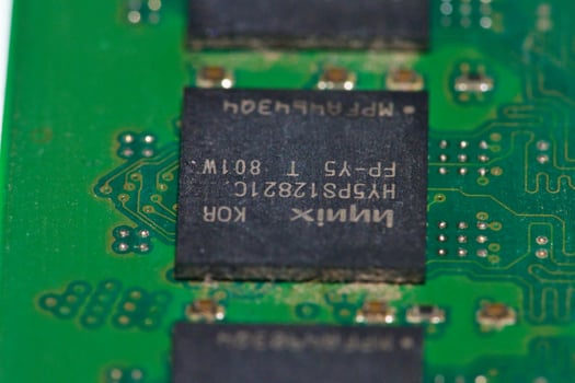 a close up of a green electronic circuit board photo
