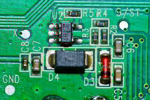 a close up of a green electronic circuit board photo