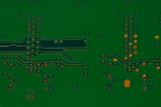 a close up of a green electronic circuit board photo