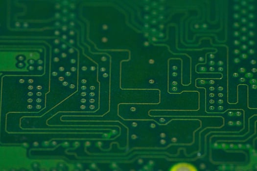 a close up of a green electronic circuit board photo