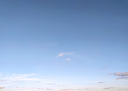 Clear blue sky texture and white fluffy cloud nature background. The sun shines bright in the daytime in summer photo