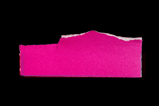 Ripped pink paper piece on isolated black background, torn paper with white edges photo