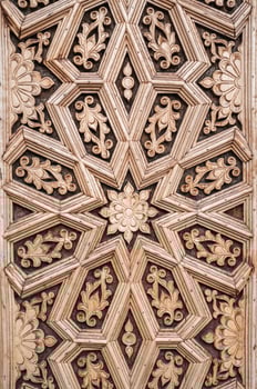 oriental Islamic pattern Uzbek traditional ornament on wooden carved door in Tashkent in Uzbekistan close up photo