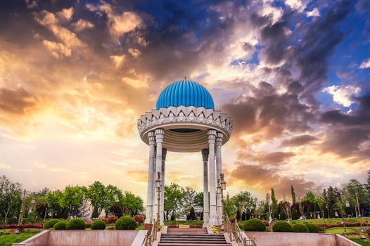monument Patriots Memorial white rotunda with a blue dome in park in spring in Tashkent in Uzbekistan photo