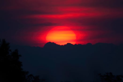 Fiery Sunset Over Silhouetted Mountains photo
