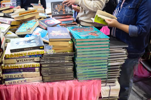New Delhi, India, May 17 2024 - Variety of Books on shelf inside a book-stall at Delhi International Book Fair, Selection of books on display in Annual Book Fair at Bharat Mandapam complex photo