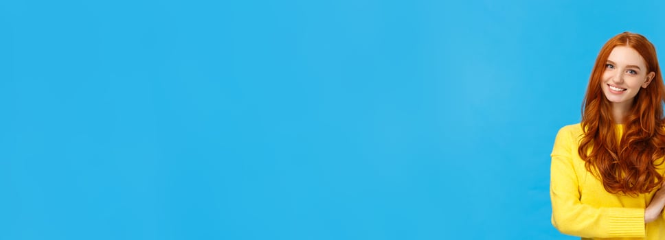 Consumer, shopping and fashion concept. Attractive ginger girl, redhead woman making reservetion, place order four products, smiling and gazing friendly camera, counting with fingers, blue background photo