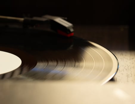 vinyl record with clear sound tracks and stylus, focus on sound tracks records, old style, classic music concept photo