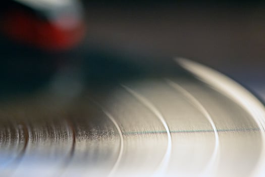 vinyl record with clear sound tracks and stylus, focus on sound tracks records, old style, classic music concept photo