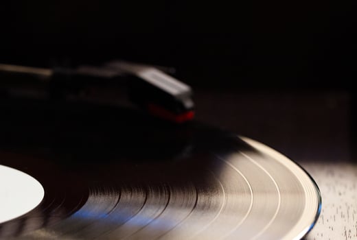 vinyl record with clear sound tracks and stylus, focus on sound tracks records, old style, classic music concept photo