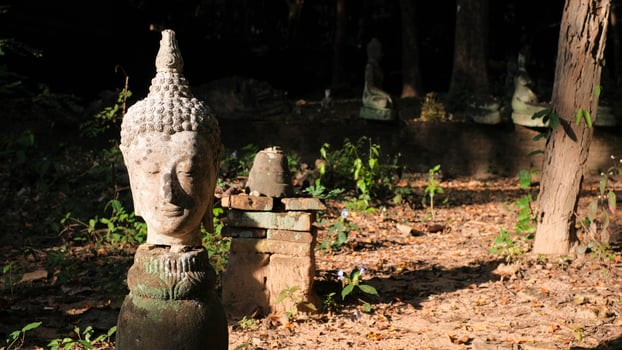 Image of ancient head of Thai Lanna Buddha at cave temple in Chaingmai, Thailand. photo