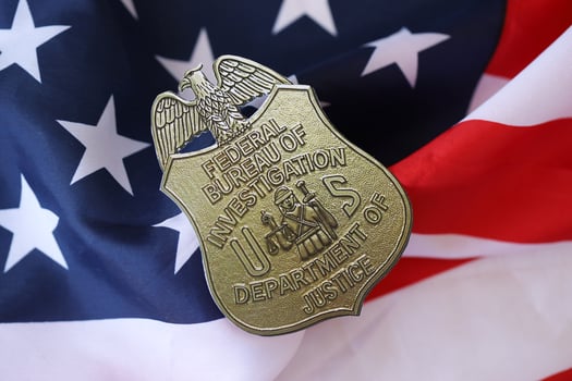 KYIV, UKRAINE - MARCH 9, 2024 US FBI Federal Bureau of Investigation badge on United States of America flag photo