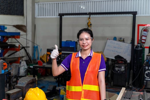Construction worker, Asian woman engineer portrait of cheerful happy and thumbs up in industrial workshop. photo