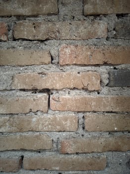 Background of a wall made of dark brown bricks. photo
