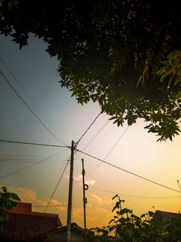 Beautiful sunset in Asia with electric cable poles photo