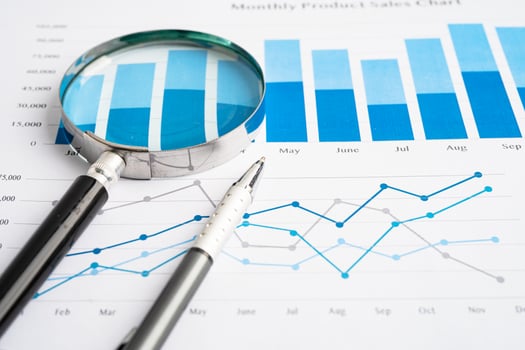 Magnifying glass on spreadsheet and graph paper. Financial development, Banking Account, Statistic, Investment Analytic research data economy, Business. photo