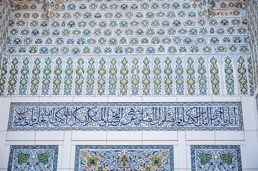 Uzbek ceramic tile decor with oriental Arabic patterns and ornaments on portal of Minor Mosque in Tashkent in Uzbekistan photo