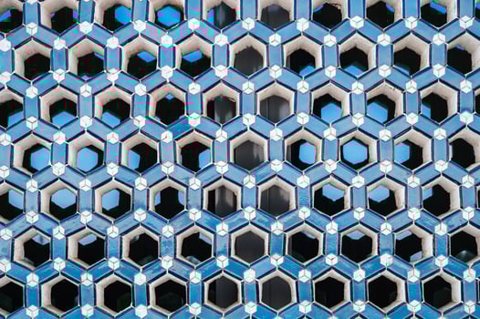 lattice with pattern on ceramic tile window in Uzbek Islamic Mosque Minor in Uzbekistan photo
