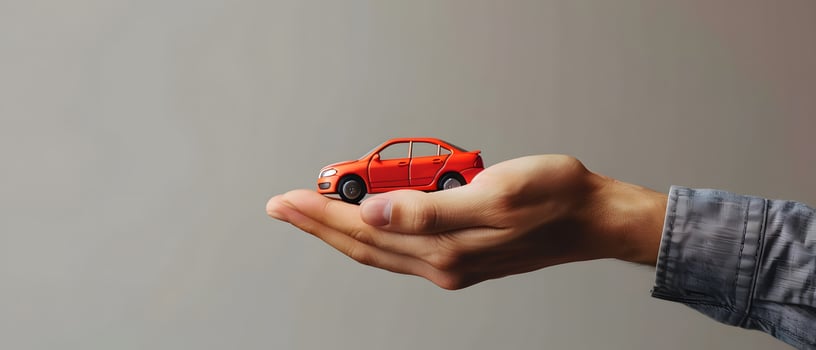 Hand holding toy car photo