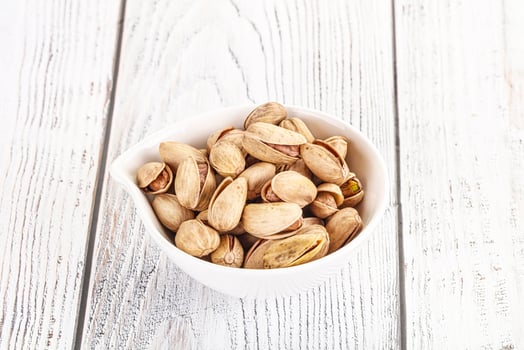 Salted tasty pistachio nuts heap photo