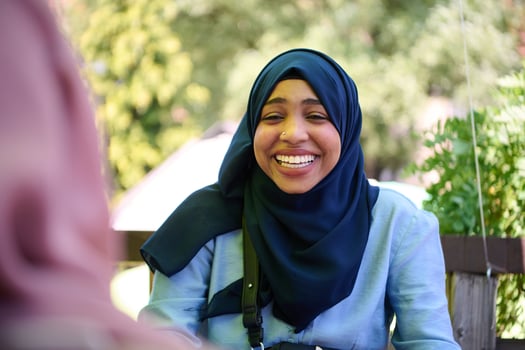 Middle Eastern Muslim Woman Enjoying Coffee and Conversation with Friend in Nature photo