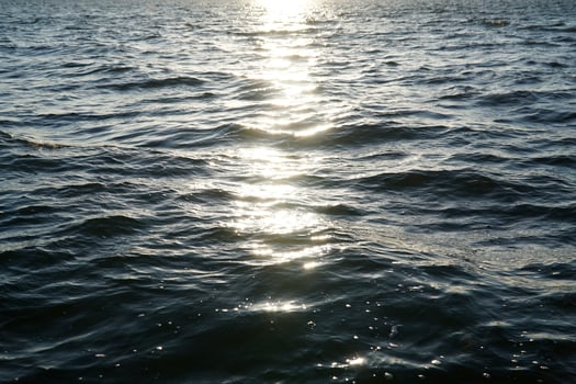 Sun reflecting in water surface photo