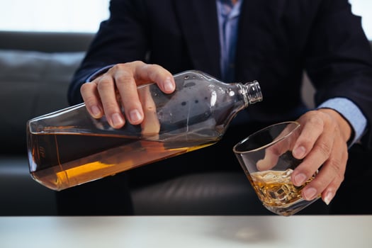 businessman sits alone in his office drinking brandy after discussing and agreeing with investors to do business in meeting until reaching satisfactory conclusion. concept of relaxing with brandy photo