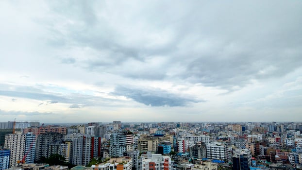 Wide shot of a modern and busy city with dark clouds photo