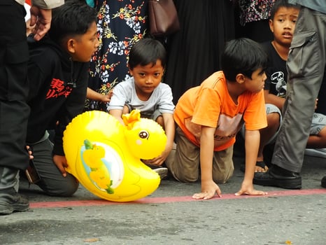 Surakarta City, Central Java, Indonesia, May 15, 2024. Crowd people watching a parade at Slamet Riyadi Street. photo