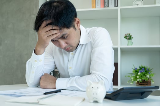 Stressed and headache asian man with large bills or invoices no money to pay to expenses and credit card debt. shortage, Financial problems, mortgage, loan, bankruptcy, bankrupt, poor, empty wallet photo