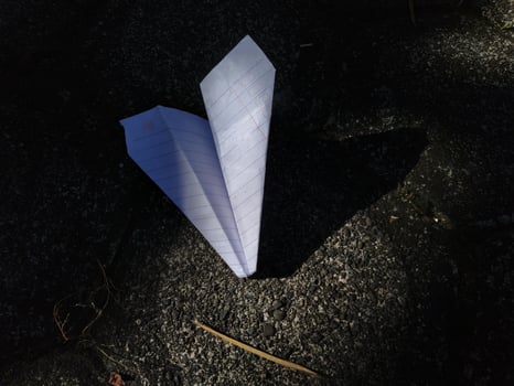 paper airplane on the paving floor, text space photo