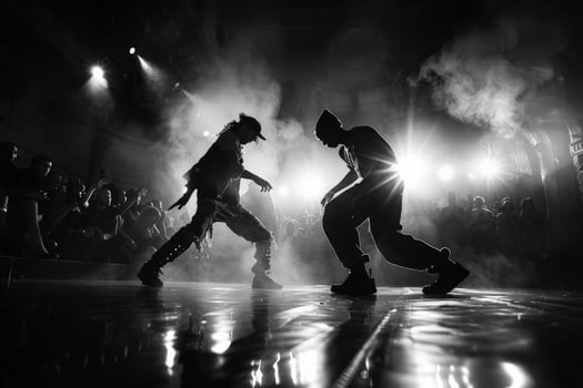 Black and white photo of two men dancing gracefully on stage in front of crowd