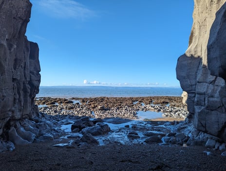 Scenic Coastal View from Inside a Rocky Cave photo