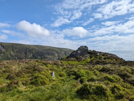 Scenic Mountain Landscape with Lush Greenery and Blue Sky photo
