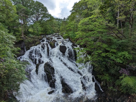 Beautiful Waterfall in Lush Green Forest Scenery photo