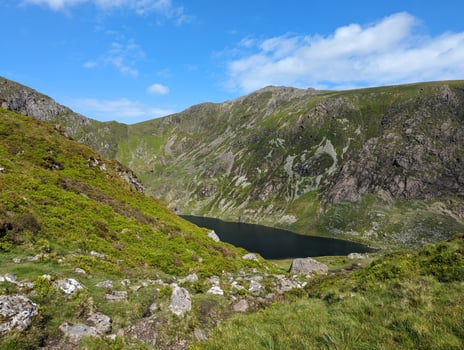 Scenic Mountain Lake in Snowdonia, Wales Under a Clear Blue Sky photo