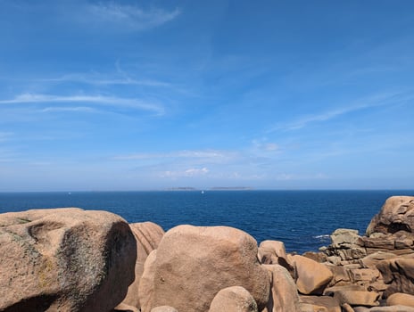 Coastal Serenity Pink Granite Rocks Meet Azure Waters on the Brittany Shore photo