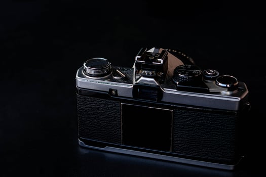 Vintage film camera on dark surface photo