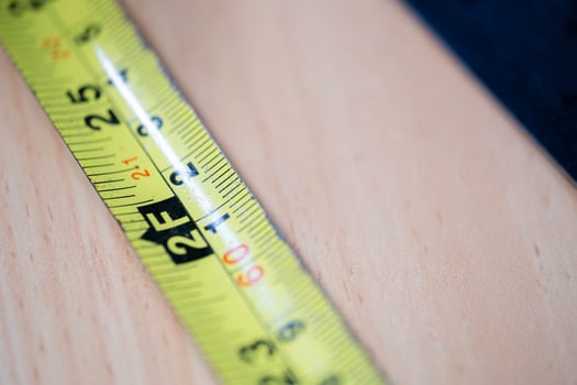 Tape measure and metal ruler on wooden desk photo