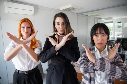 Three businesswomen hand gesturing Break the bias in the office. Feminist movement photo