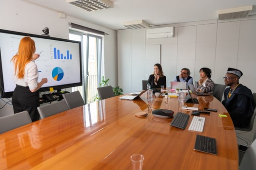 A businesswoman presents slides to her colleagues during a conference photo