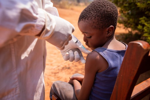 Close-up of a doctor injecting the vaccine to a child in africa photo