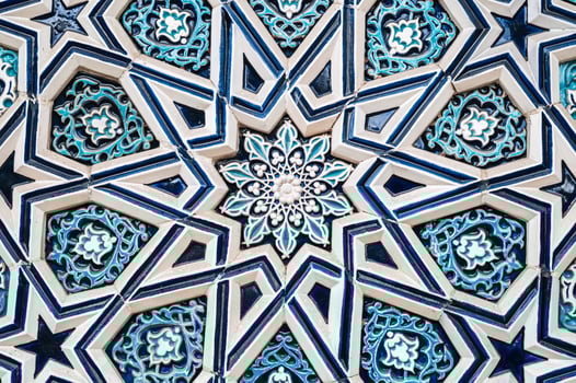 tile Uzbek mosaic with oriental Arabic Islamic pattern decorated with blue and white floral ornament with stars photo