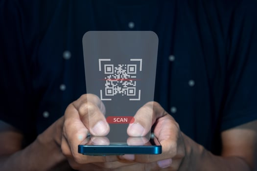 Male hand using a smart phone to scan QR code. QR code payment, registration, E-wallet or cashless technology concept. photo