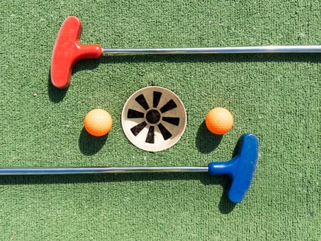 Golf stick and ball on green grass close up. photo